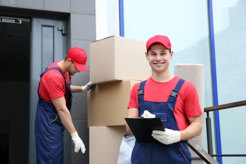 Workers securing fragile furniture inside a van