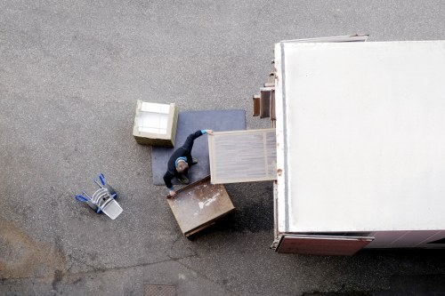 Upright piano being moved through a narrow Greenwich staircase